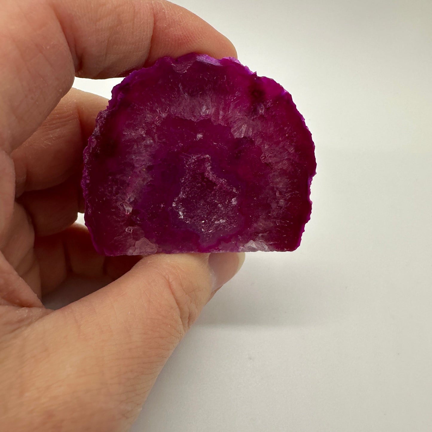 Pink agate geode with sparkling crystalline interior and soft pink-purple tones for emotional support