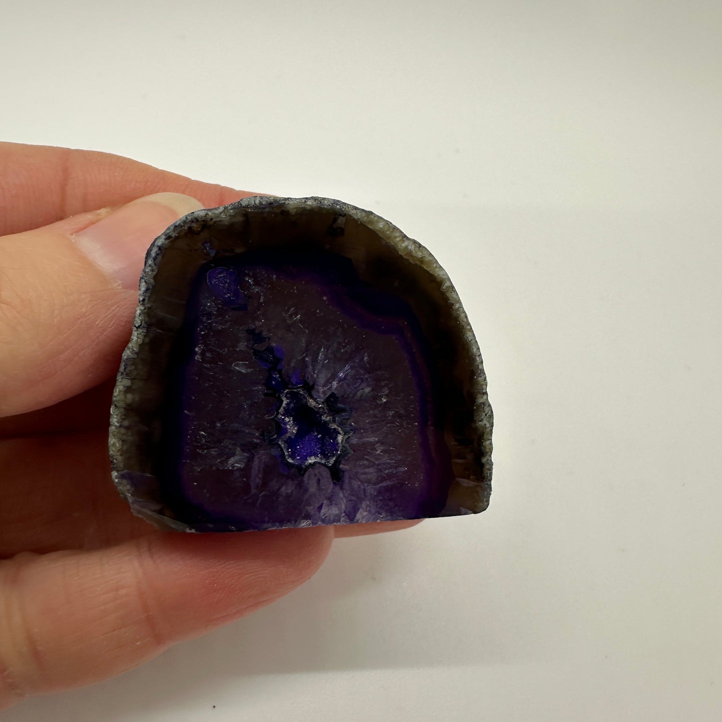 Purple agate geode with sparkling crystalline interior and rich purple tones for calm and clarity