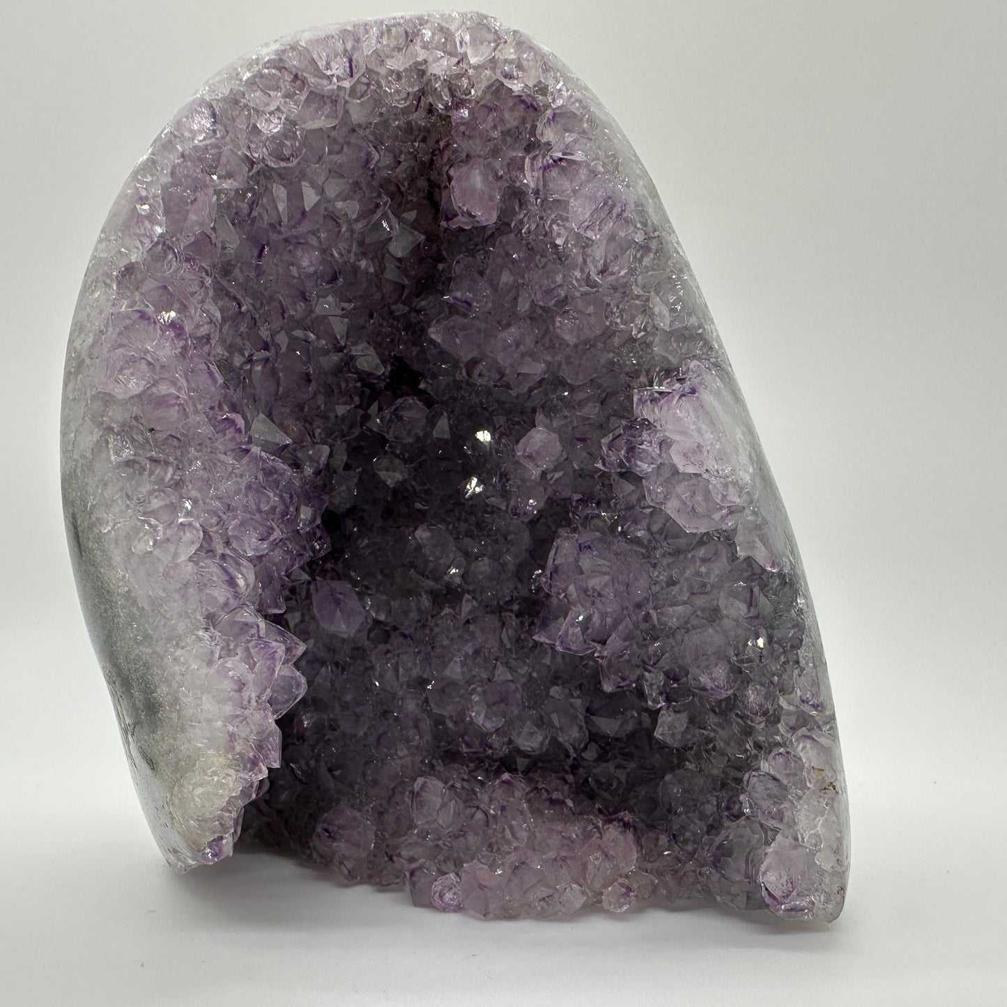 Amethyst geode with sparkling violet crystals — symbol of peace, intuition, and emotional healing