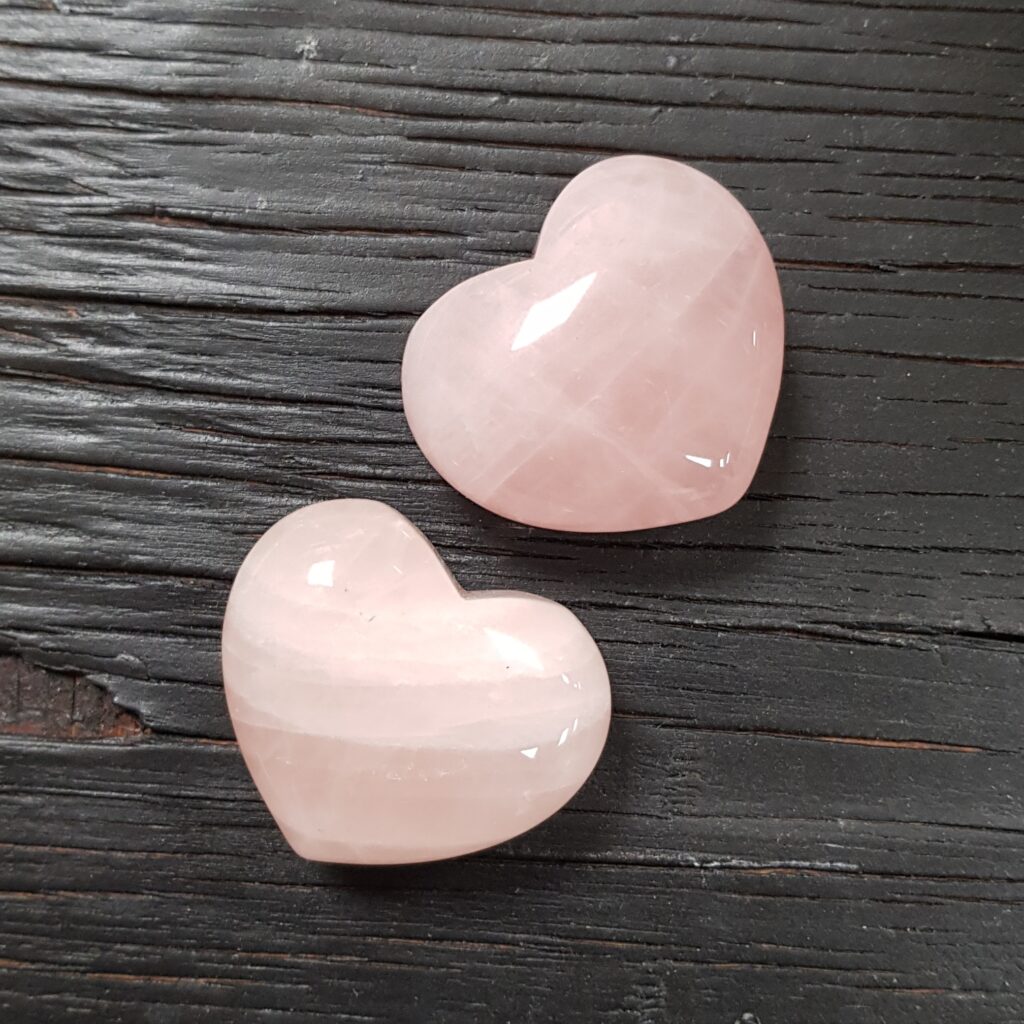 Rose quartz heart crystals with a gentle pink glow symbolising love, comfort, and emotional healing