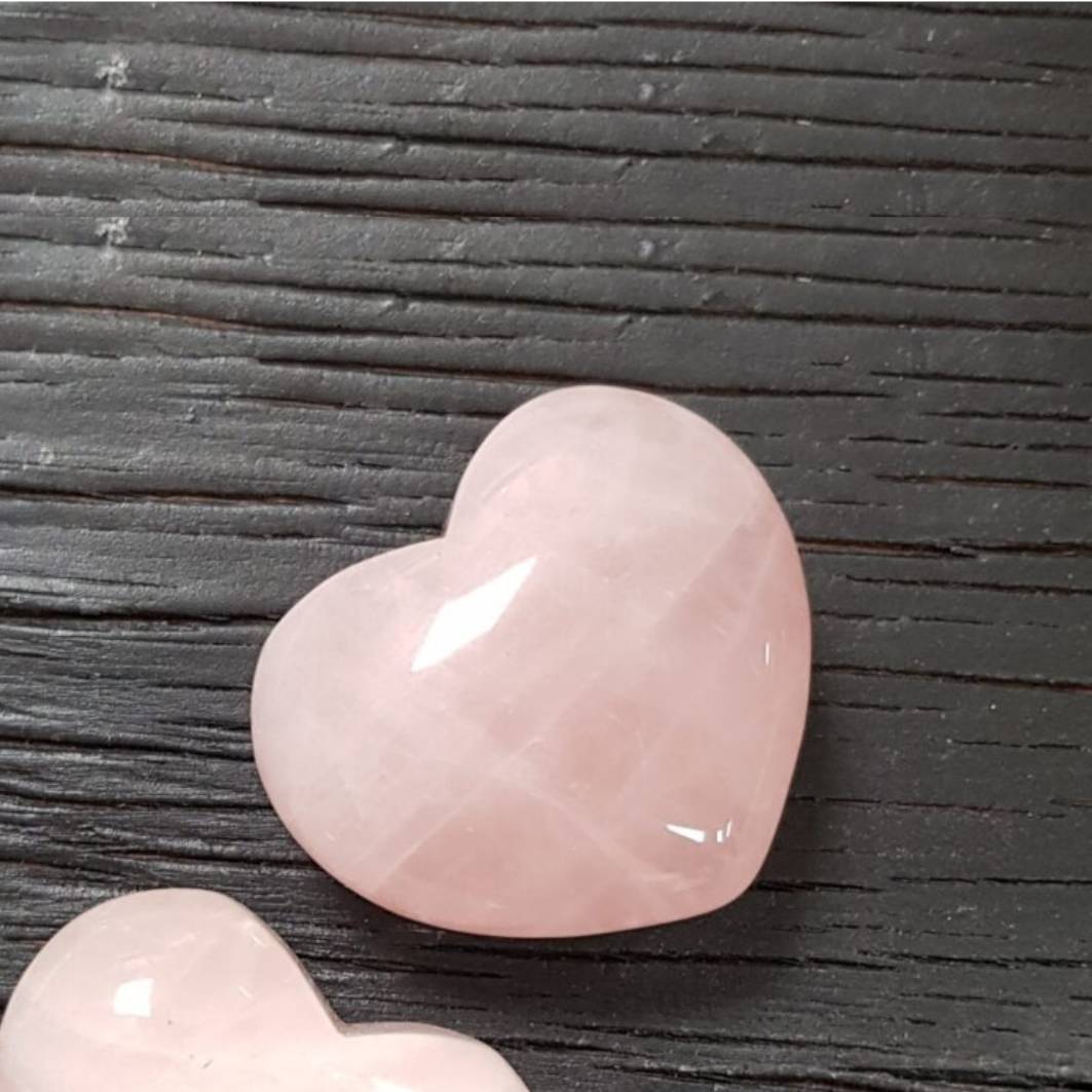 Rose quartz heart crystal with a gentle pink glow symbolising love, comfort, and emotional healing