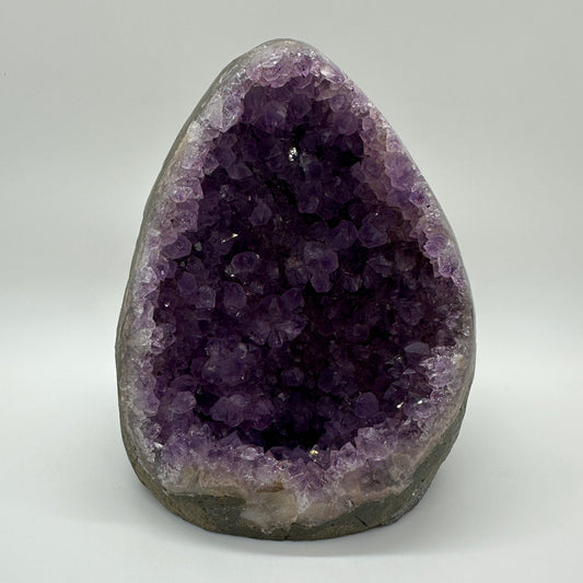 Amethyst geode with sparkling violet crystals — symbol of peace, intuition, and emotional healing